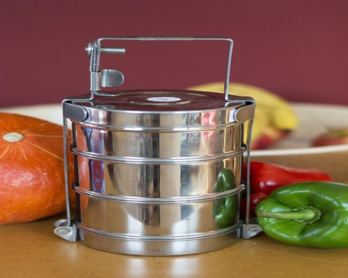 A freshly prepared Indian meal served in a stainless steel tiffin box