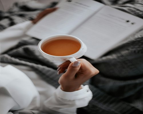 A quiet evening setting with a book and a warm cup of herbal tea